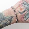 5mm stainless steel curb chain bracelet shown on a women's wrist