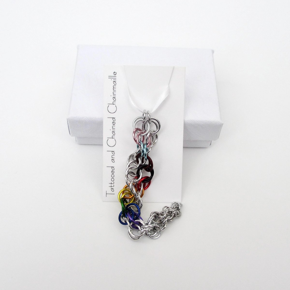 Progress pride flag icicle ornament, handmade chainmail spiral in rainbow, trans, and BIPOC colors