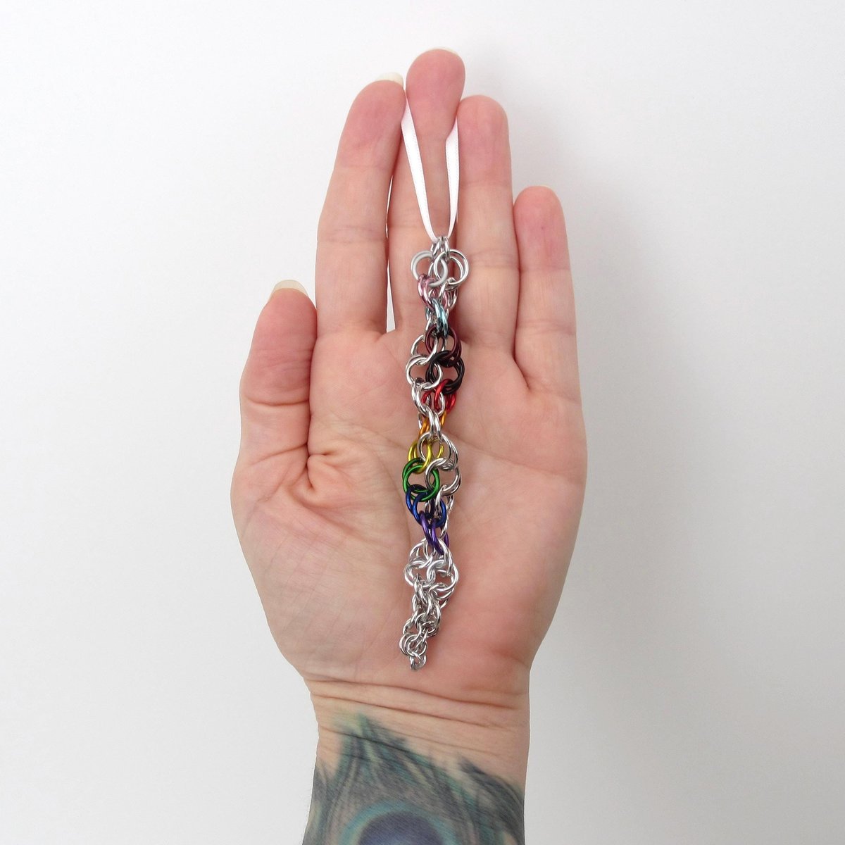 Progress pride flag icicle ornament, handmade chainmail spiral in rainbow, trans, and BIPOC colors